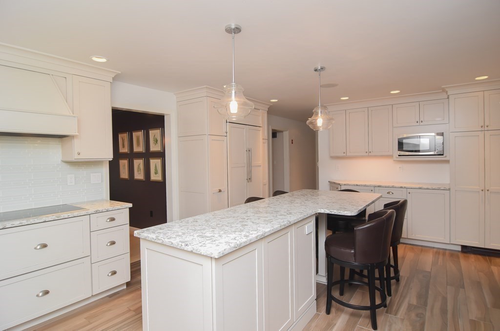 73 Cynthia Road Needham, MA 02494 - Photo 5 of 41 a kitchen with a table chairs refrigerator and microwave