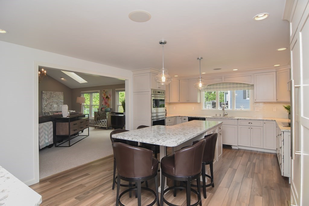 73 Cynthia Road Needham, MA 02494 - Photo 6 of 41 a kitchen with a dining table chairs wooden floor appliances and cabinets