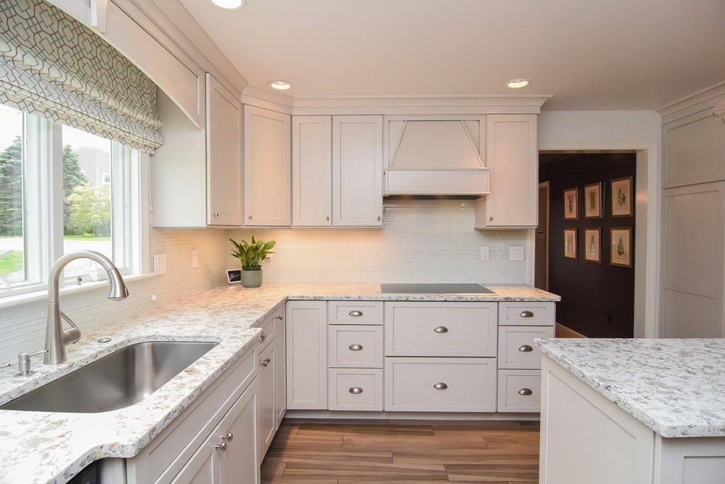73 Cynthia Road Needham, MA 02494 - Photo 7 of 41 a kitchen with granite countertop a sink a stove and cabinets