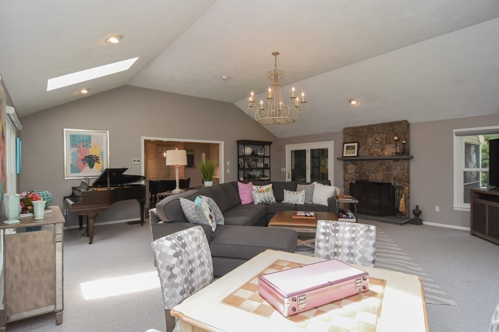 73 Cynthia Road Needham, MA 02494 - Photo 8 of 41 a living room with furniture a chandelier and a fireplace