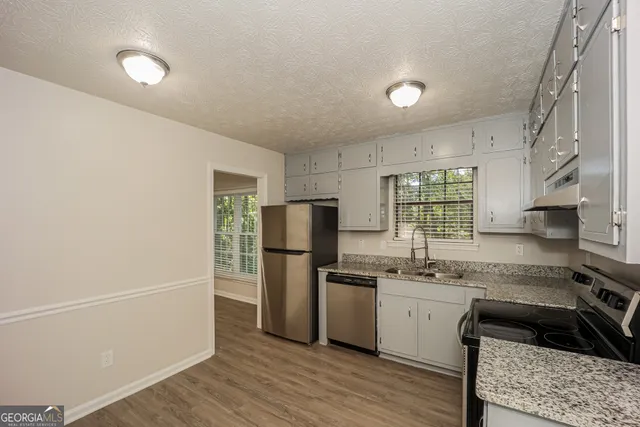 a kitchen with a refrigerator and a sink