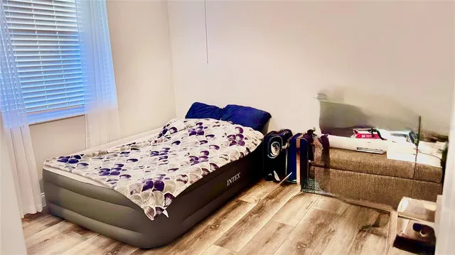 a living room with furniture flowerpot and window