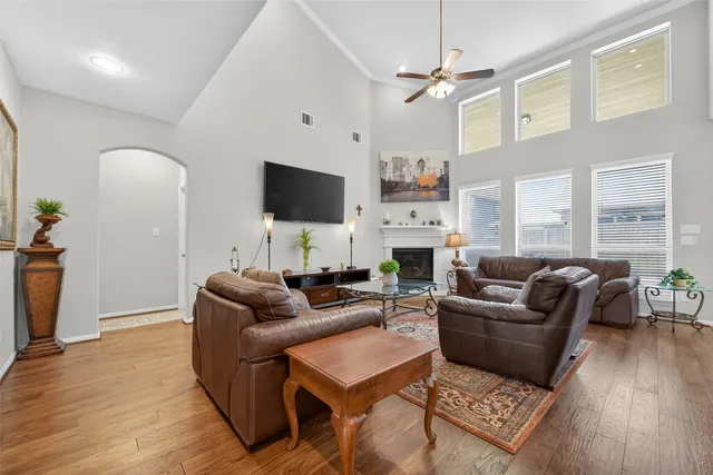 a living room with furniture a fireplace and a flat screen tv