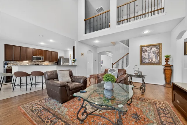a living room with furniture and kitchen view