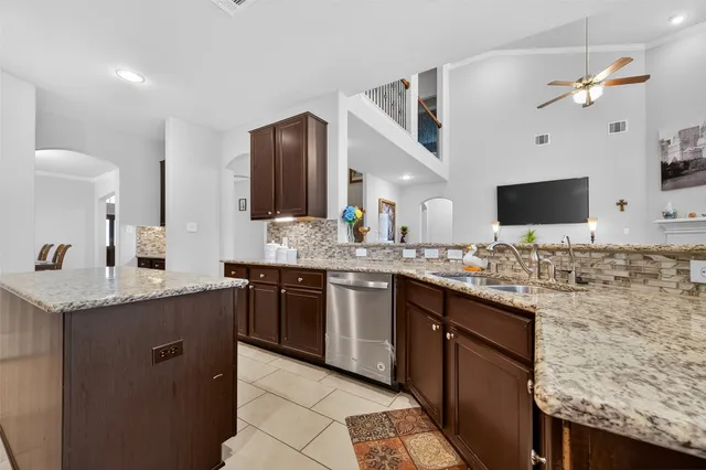 a kitchen with stainless steel appliances granite countertop a sink and stove