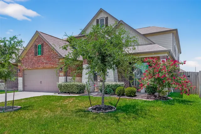 a front view of a house with a garden and plants