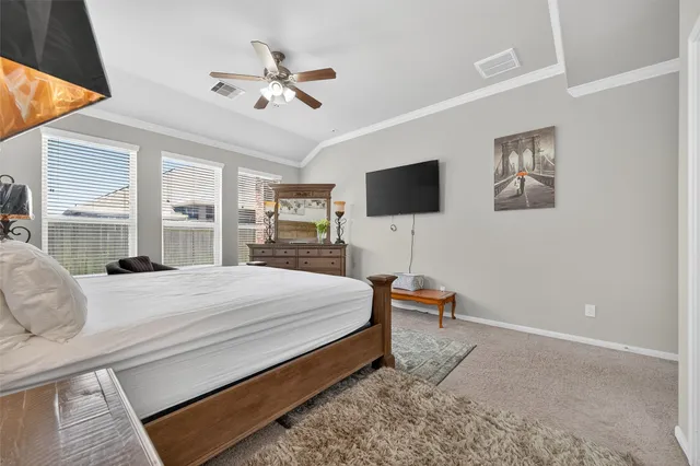 a bedroom with a bed and a flat screen tv