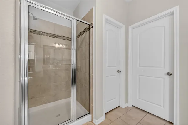a bathroom with a glass shower door