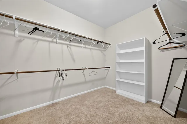 a view of walk in closet with empty racks