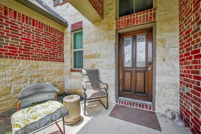 a view of a brick house with floor to ceiling windows