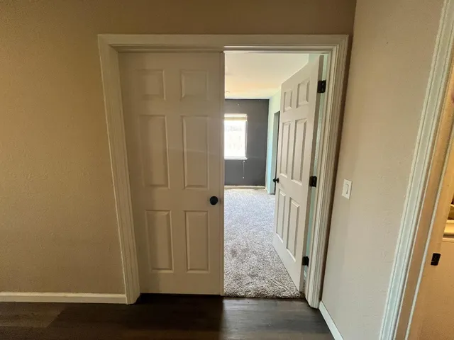 a view of room with a ceiling fan and a window