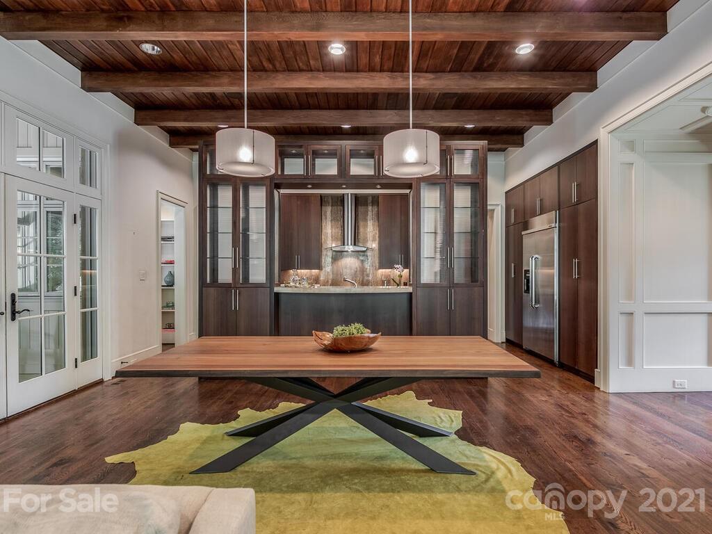 8424 Eagle Glen Charlotte, NC 28210 - Photo 16 of 48 a living room with stainless steel appliances kitchen island granite countertop furniture and a wooden floors