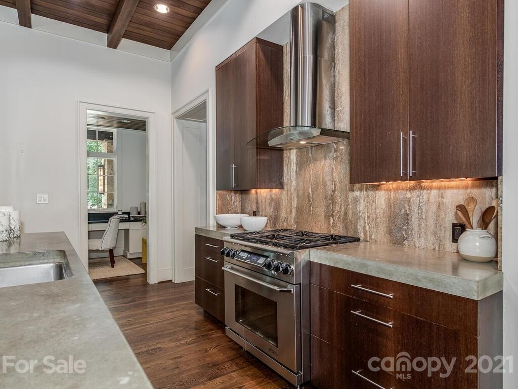 8424 Eagle Glen Charlotte, NC 28210 - Photo 18 of 48 a kitchen with a stove and a sink