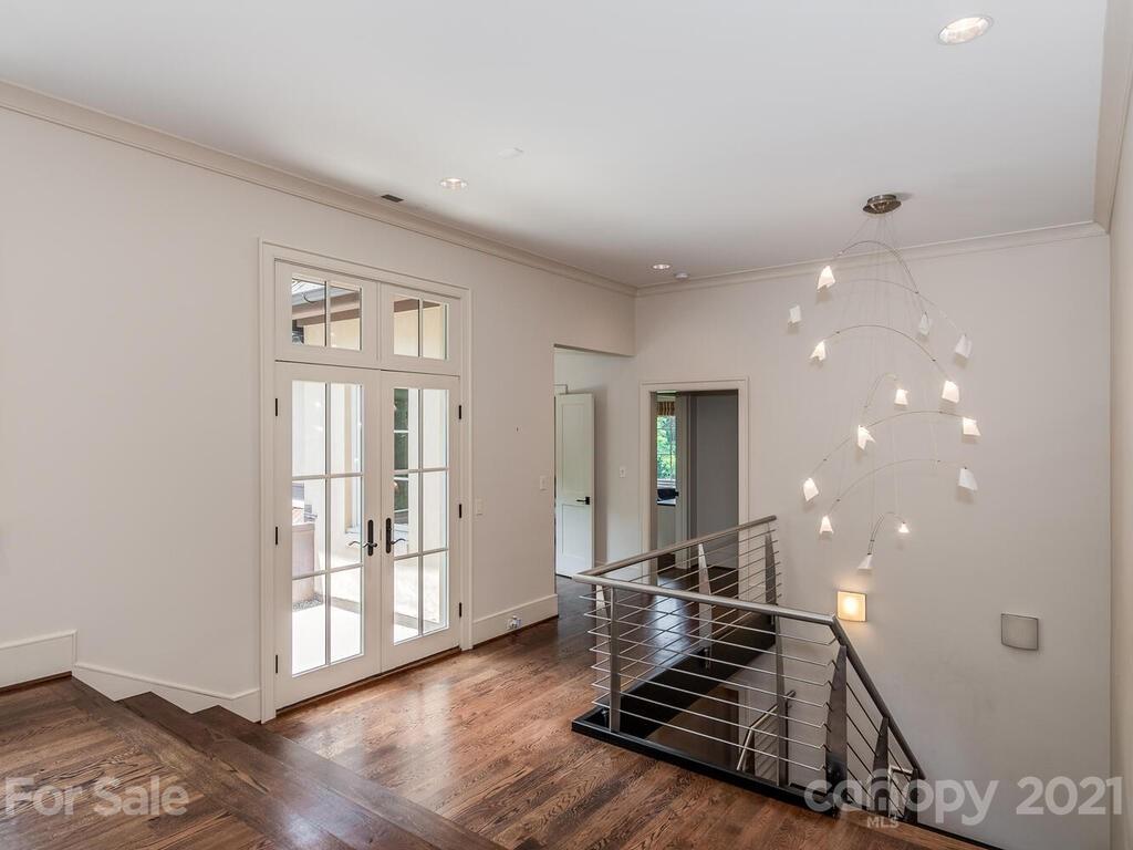 8424 Eagle Glen Charlotte, NC 28210 - Photo 27 of 48 a room with lots of wooden furniture and windows