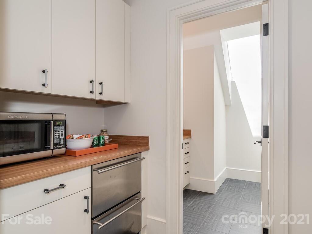8424 Eagle Glen Charlotte, NC 28210 - Photo 29 of 48 a kitchen with granite countertop white cabinets and a stove