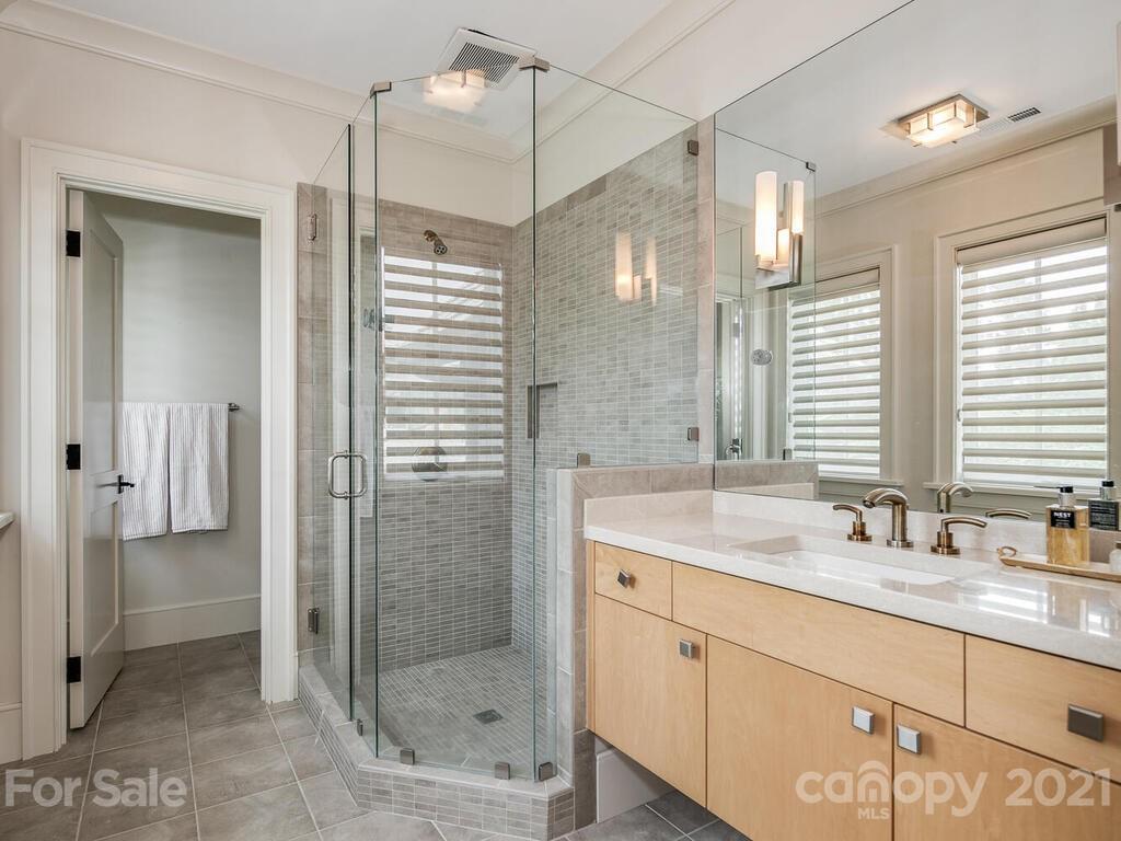 8424 Eagle Glen Charlotte, NC 28210 - Photo 36 of 48 a bathroom with a shower sink and mirror