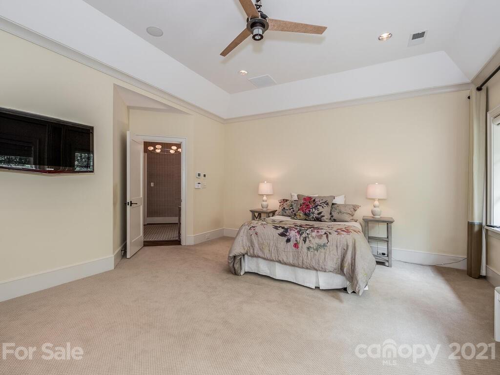8424 Eagle Glen Charlotte, NC 28210 - Photo 39 of 48 a spacious bedroom with a bed and a flat screen tv