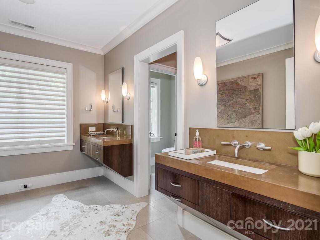 8424 Eagle Glen Charlotte, NC 28210 - Photo 41 of 48 a bathroom with a sink double vanity and a mirror