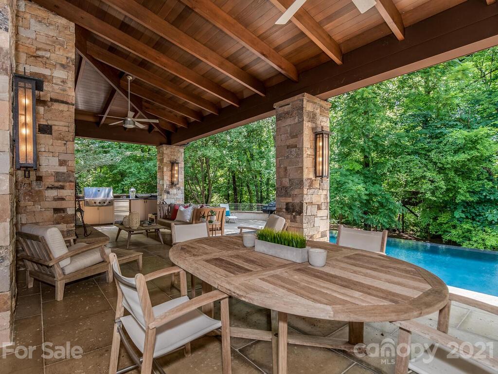 8424 Eagle Glen Charlotte, NC 28210 - Photo 46 of 48 a view of a patio with table and chairs and couches with wooden floor and fence