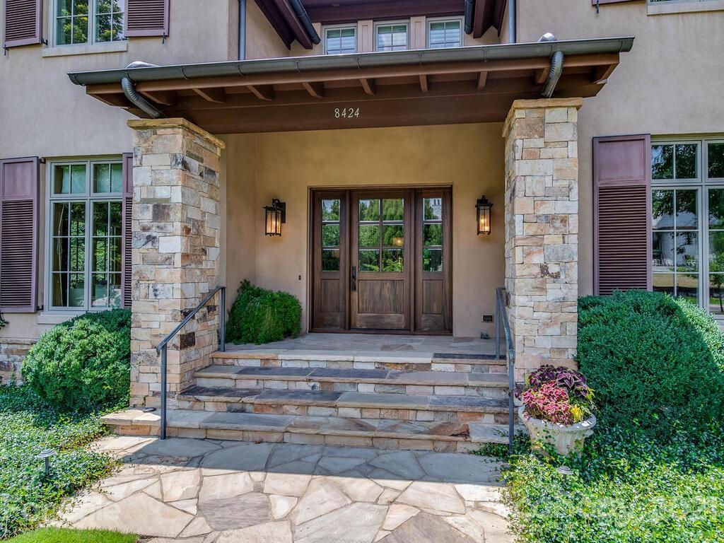 8424 Eagle Glen Charlotte, NC 28210 - Photo 5 of 48 a front view of a house with potted plants