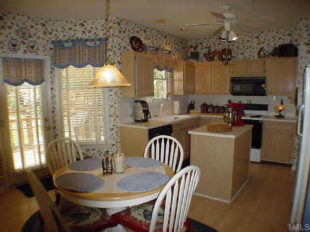8801 Attingham Drive Raleigh, NC 27615 - Photo 3 of 10 Kitchen center island, lovely bay window area with door to fabulous back deck and yard