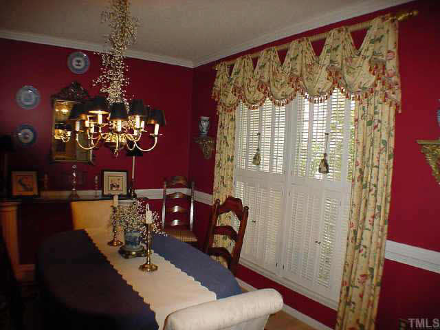 8801 Attingham Drive Raleigh, NC 27615 - Photo 4 of 10 Formal Dining Room, hardwood floors, shutters on the windows
