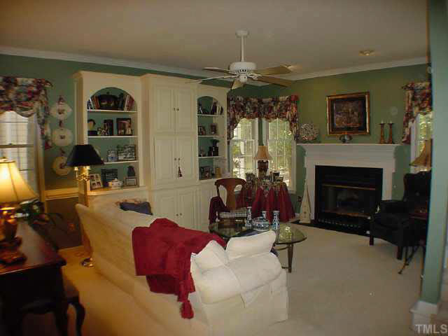 8801 Attingham Drive Raleigh, NC 27615 - Photo 6 of 10 Family Room with built in bookcases, gas log fireplace