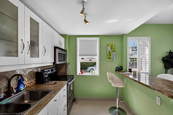 a living room with kitchen island furniture and a wooden floor
