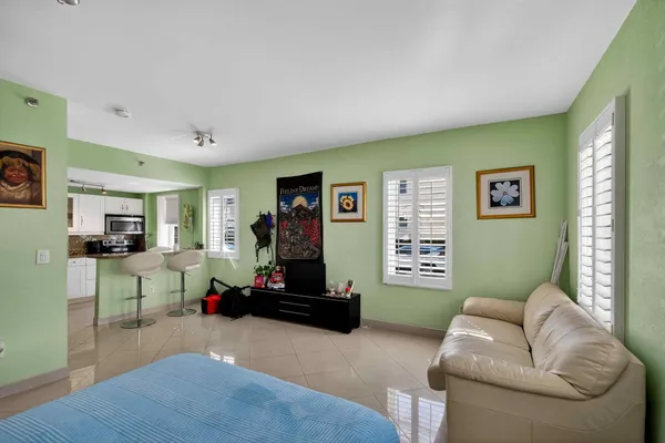 a living room with furniture window and a flat screen tv