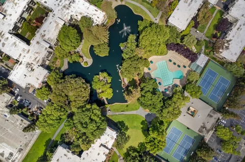 an aerial view of a house with a yard and garden