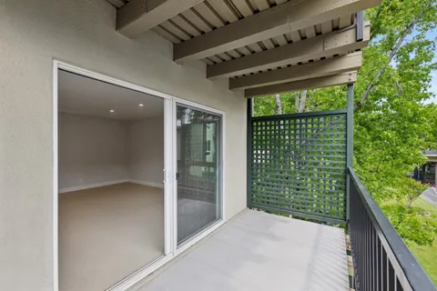 a view of a backyard with porch and garden