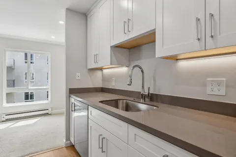 a kitchen with a sink and cabinets