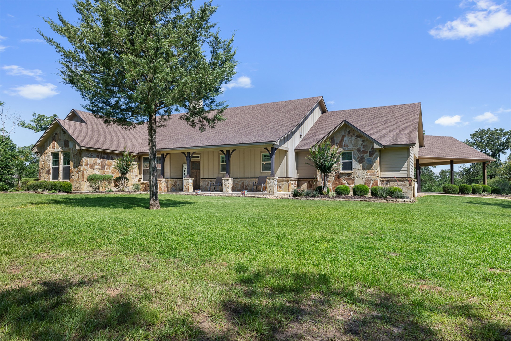 1306 22 Hills Road Gause, TX 77857 - Photo 1 of 40 Stone and siding exterior with a covered front entry and a covered carport