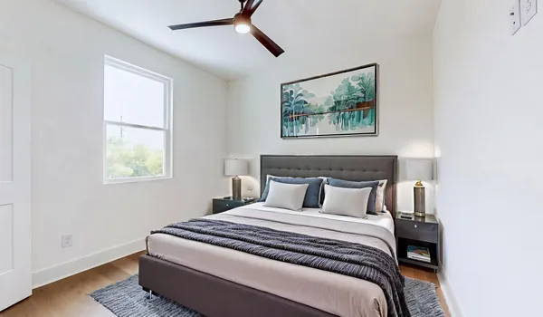 a bedroom with bed and window