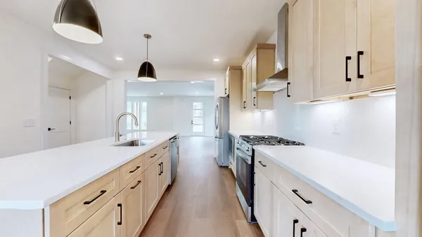a kitchen with granite countertop a sink stainless steel appliances and cabinets