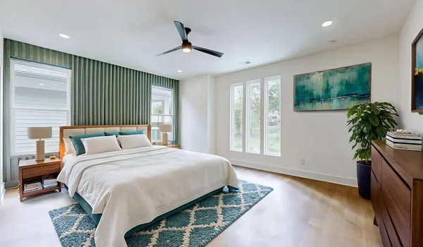 a bedroom with a bed and a potted plant