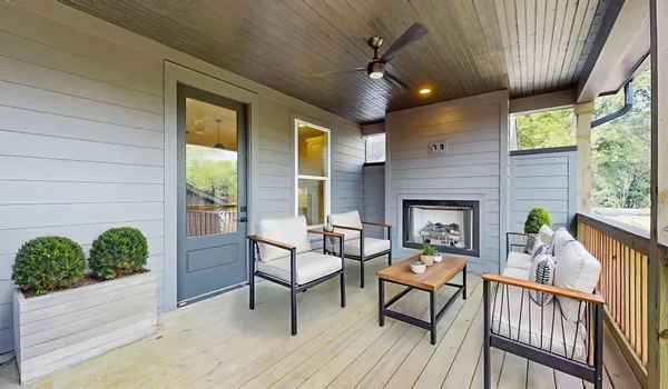 a view of a porch with furniture and a yard