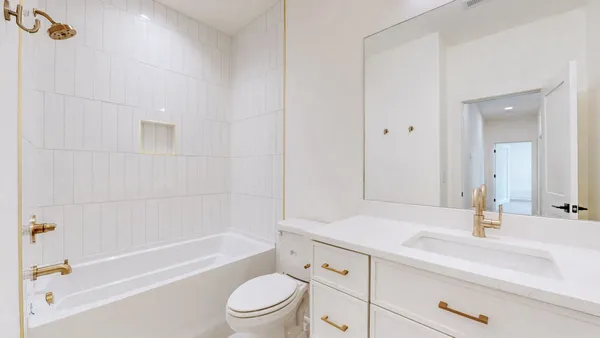 a bathroom with a sink a toilet and bathtub