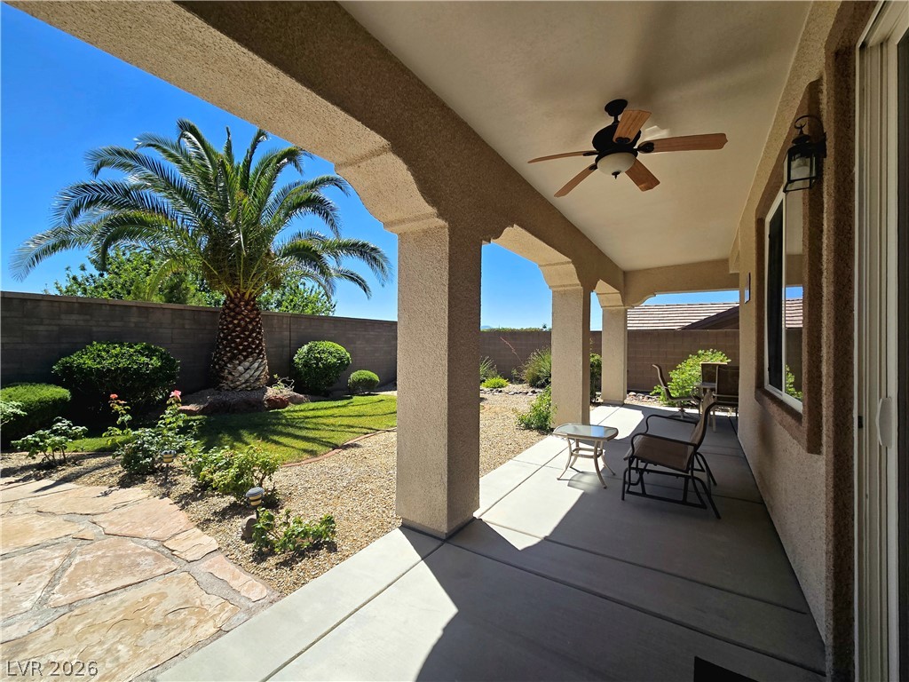2567 Dirleton Place Henderson, NV 89044 - Photo 54 of 67 An inviting covered patio offers ample space for outdoor relaxation, overlooking a xeriscaped yard and privacy wall.