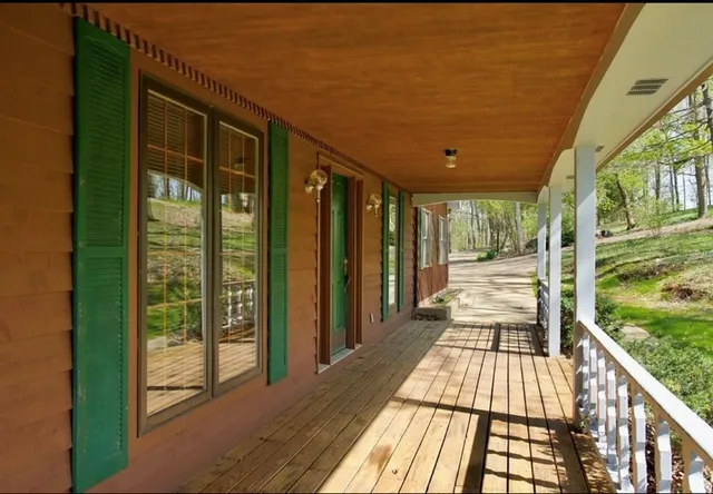 a view of a balcony with wooden floor