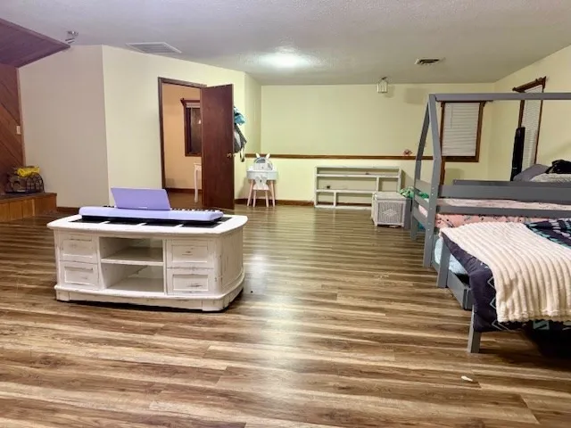 a room with wooden floor and furniture