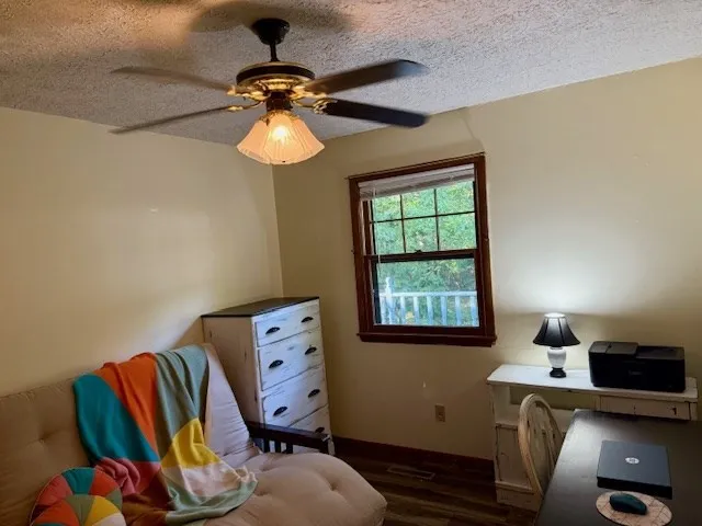 a kitchen with granite countertop a sink and white cabinets