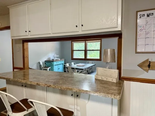 a kitchen with stainless steel appliances kitchen island granite countertop a refrigerator stove and sink