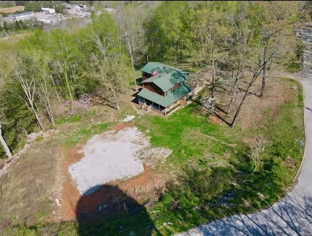 a view of a room with wooden floor and large windows