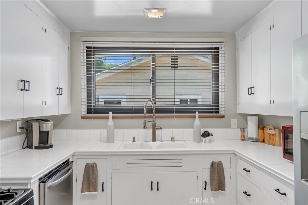 4231 Maplewood Place Riverside, CA 92506 - Photo 14 of 33 a kitchen with a sink and a window