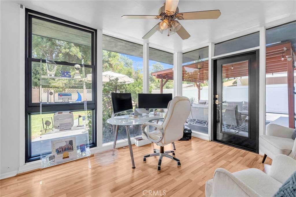 4231 Maplewood Place Riverside, CA 92506 - Photo 7 of 33 a workspace with wooden floor and a large window