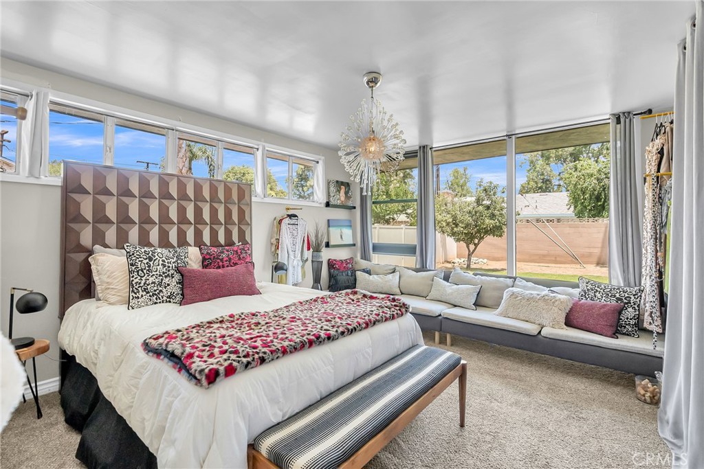 4231 Maplewood Place Riverside, CA 92506 - Photo 9 of 33 a bedroom with a bed and a couch next to a window