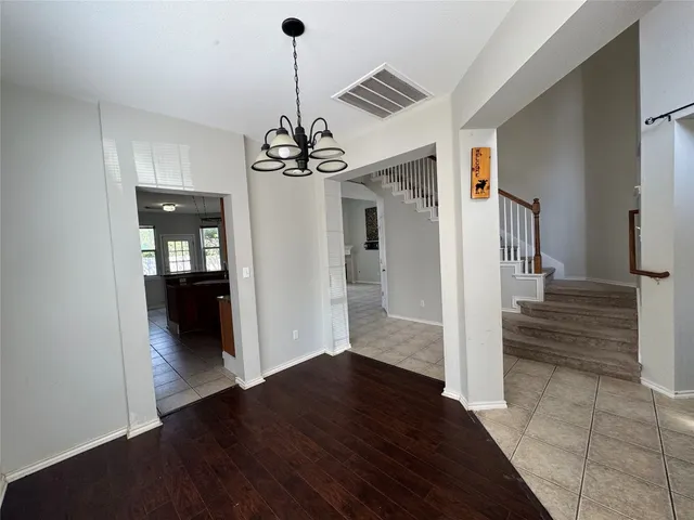 a view of a hallway view with wooden floor and staircase