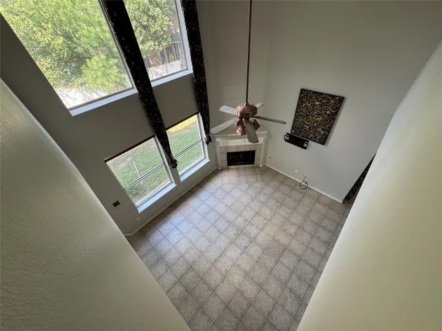a view of a room with wooden floor and windows