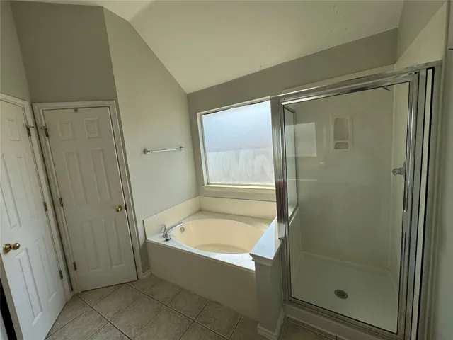 a bathroom with a bathtub and a shower